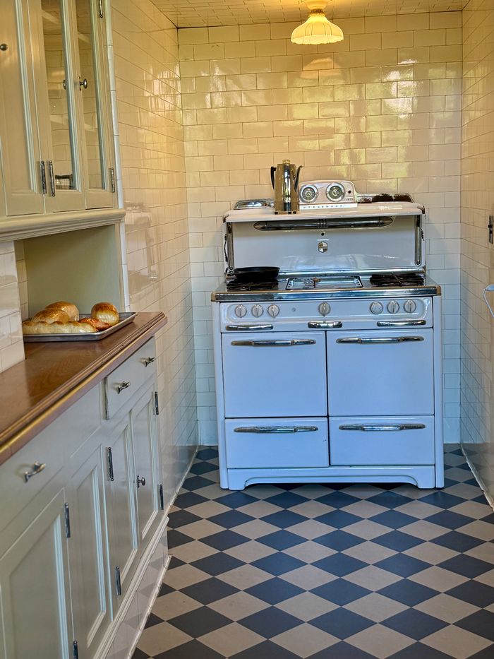 Charming vintage kitchen featuring a classic white stove and elegant tile design.